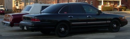 Black sedan, side view, parked next to maroon sedan