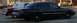 1989 Lincoln Town Car - A black sedan is parked alongside a maroon sedan on a street.