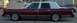 1989 Lincoln Town Car - Side view of a maroon 1989 Lincoln Town Car a white vinyl roof and wire wheels.
