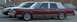 1989 Lincoln Town Car - A maroon sedan with a vinyl roof is parked on a street next to other vehicles.