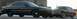 1989 Lincoln Town Car - Two large sedans are parked next to each other, with the front of the darker vehicle prominently displayed.