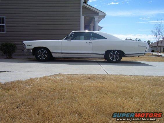 White 1965 Pontiac Catalina coupe parked in driveway