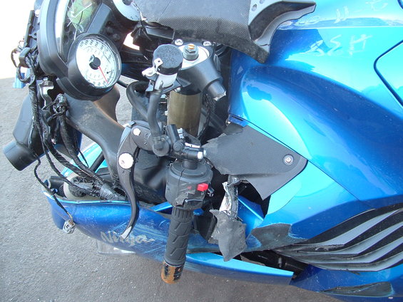dscf0073.jpg A close up shot showing the broken left handle bar.  I'm surprised the whole clutch lever didn't break off.