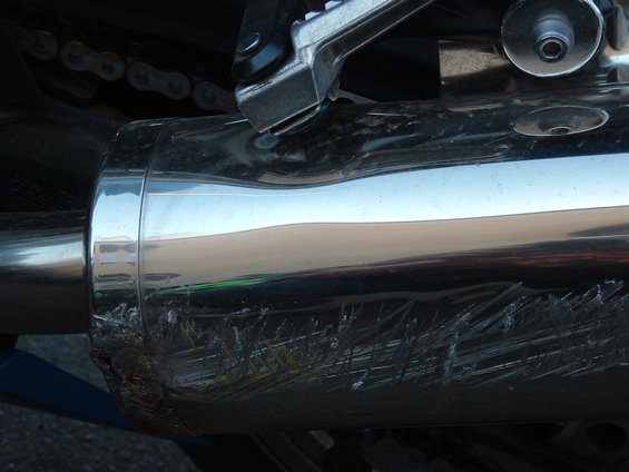 dscf0076.jpg See the wierd dent in the top of the exhaust can?  It's like the can was force upwards into the rear footpeg.  The same dent can be found on the right exhaust can as well.
