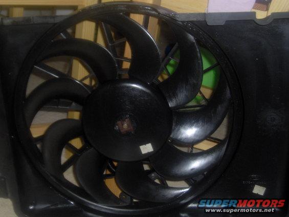 Black plastic radiator fan and shroud assembly with nine blades