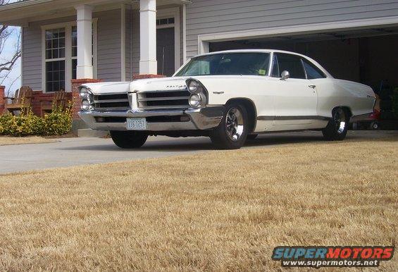 1965 Pontiac Catalina parked in front of a house, front 3/4 view
