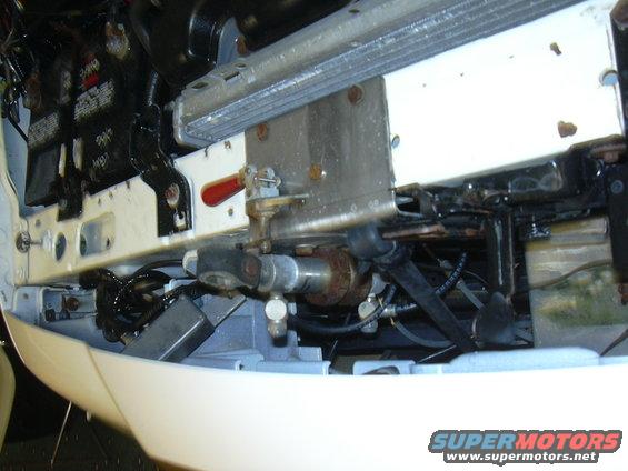 Engine bay components with radiator and fuel lines visible