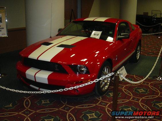 red Ford Mustang Shelby GT500 with white stripes on display