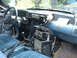 1987 Ford Mustang - The interior of a 1987 Ford Mustang shows extensive aftermarket radio equipment mounted on the dashboard and center console.