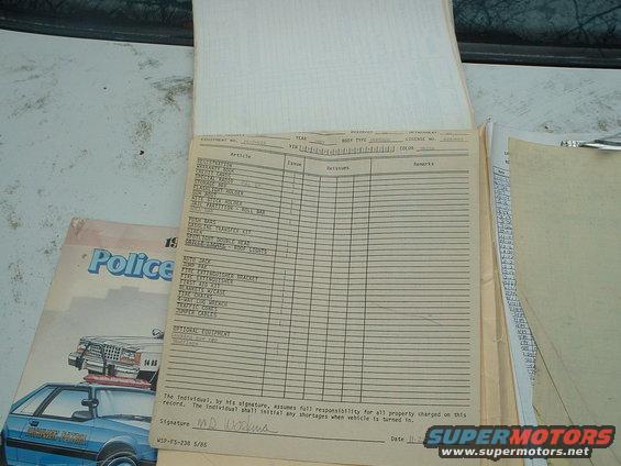 Police vehicle equipment checklist with handwritten entries and a diagram of a police car