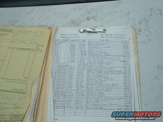 Vehicle maintenance record document with handwritten entries and printed text