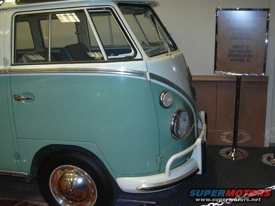 Teal and white Volkswagen Type 2 Bus front corner with a display sign