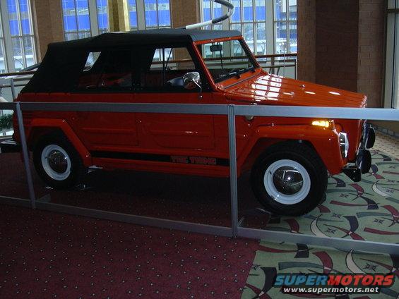 Orange Volkswagen Thing with black soft top, side view