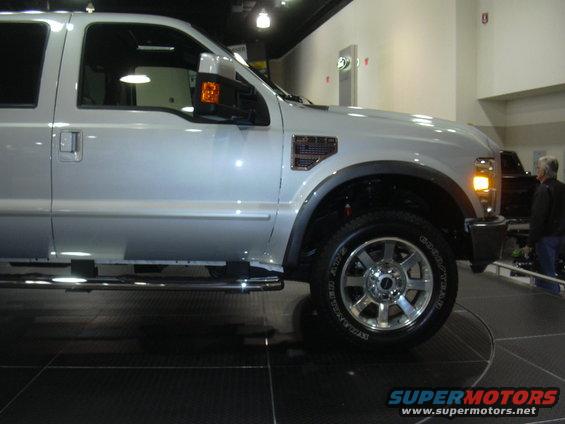 Silver Ford F-Series truck side view, showing fender vent and wheel