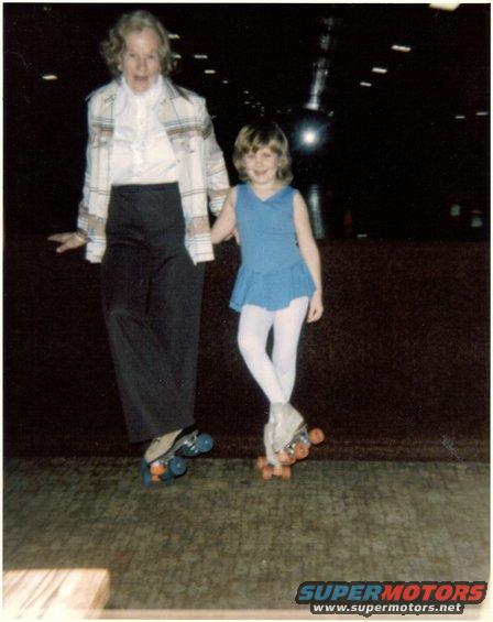 Elderly woman and young girl in roller skates at a roller rink