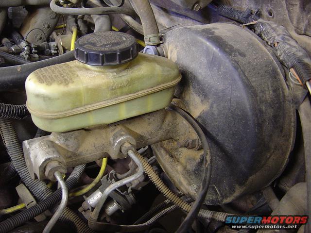 Brake master cylinder and booster assembly with yellow fluid reservoir