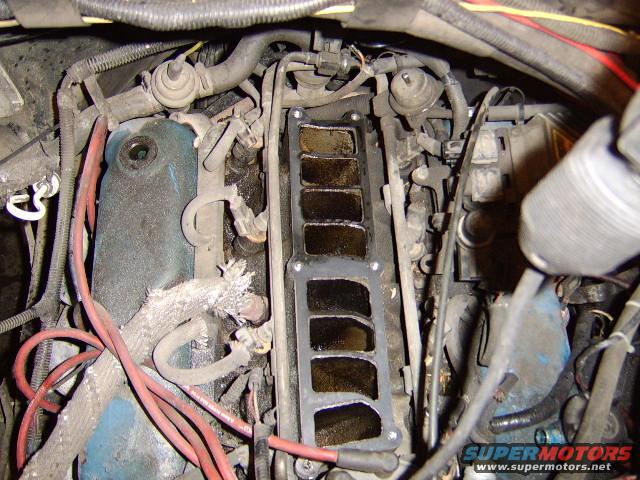 change-oil-pan-gasket-and-valve-cover-gasket-035.jpg In this pic, you can see the other end of the egr pipe going into the center of the intake. Soak it in penetrating fluid before removal