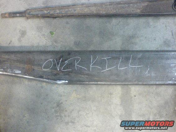 metal frame pieces with 'OVER KILL' written on one