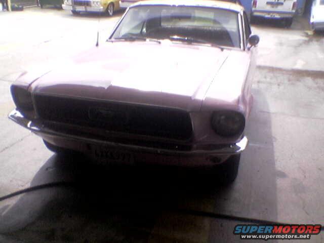 1967 Ford Mustang front view, pink color. License plate reads LMX 971
