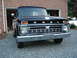 1966 Ford F-100 - Front view of a black 1965 Ford F-100 truck with a chrome grille and round headlights.