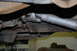 1996 Ford Bronco - Underside view of a vehicle's driveshaft and differential, with visible rust and wear on components.
