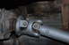 1996 Ford Bronco - Close-up view of a vehicle's driveshaft and universal joint, highlighting mechanical components.