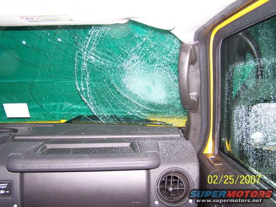 Yellow Hummer H2 interior with cracked windshield and date stamp 02/25/2007