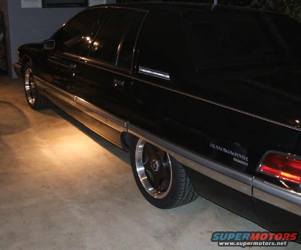 Black 1994 Buick Roadmaster sedan, rear quarter view, lowered suspension, custom wheels, chrome trim