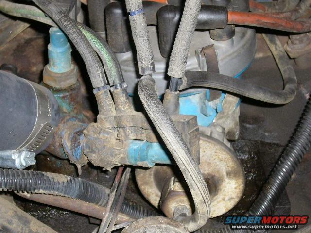 Close-up of engine parts with hoses and wires