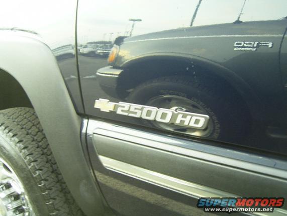 Dark blue Chevrolet 2500 HD truck side emblem and tire