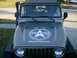 2004 Jeep Wrangler - This Jeep Wrangler features a prominent TX4WD Organization decal on its hood, along with a snorkel on the driver's side.