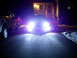 2003 Mercury Marauder - A car with intensely bright headlights illuminates the driveway at night, parked beside a pickup truck.