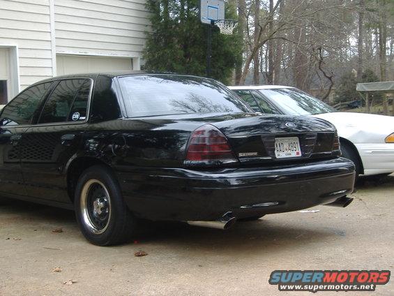Black 2001 Ford Crown Victoria rear quarter view. License plate AAD-4891