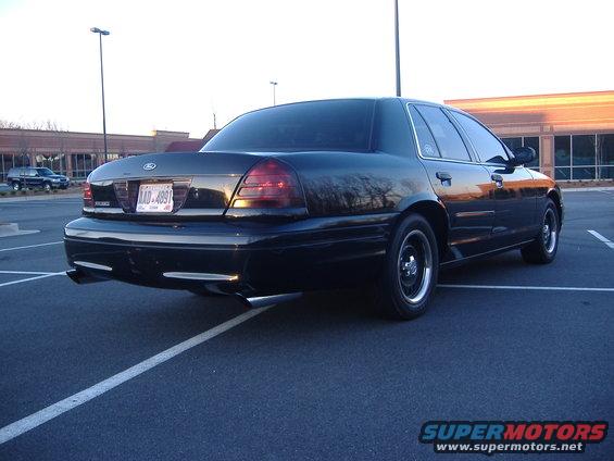 Black 2001 Ford Crown Victoria rear view with dual exhaust pipes