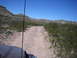 1996 Ford Bronco - Driving on a dusty track through a barren landscape under a clear blue sky.