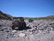1996 Ford Bronco - Several off-road vehicles navigate a , rocky terrain on a sunny day.