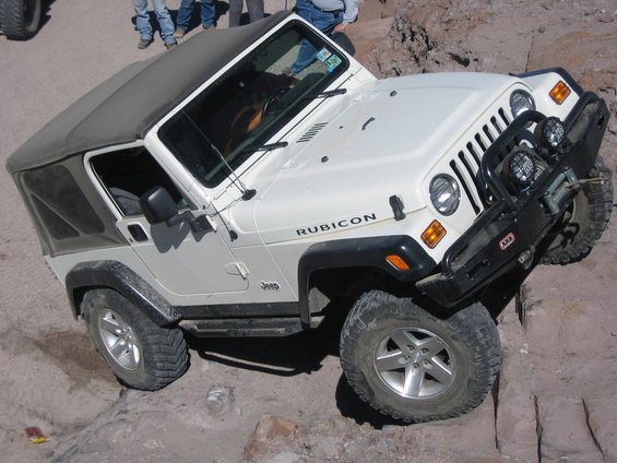 White Jeep Wrangler Rubicon on rocky terrain