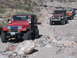 1996 Ford Bronco - Multiple Jeeps drive on a rocky, off-road path.