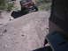 1996 Ford Bronco - An orange Jeep Wrangler navigates a dirt path, with another vehicle partially visible in the foreground.