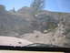 1996 Ford Bronco - Off-road vehicles navigate a challenging, rocky terrain under a clear blue sky.