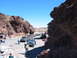 1996 Ford Bronco - A group of off-road vehicles navigate a rocky canyon under a clear blue sky.