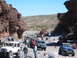 1996 Ford Bronco - A convoy of off-road vehicles navigates a rocky canyon under a clear blue sky.