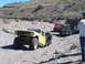 1996 Ford Bronco - Several off-road vehicles traverse a , mountainous terrain on a sunny day.