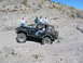 1996 Ford Bronco - A black Jeep Wrangler navigates a challenging off-road trail with onlookers present.