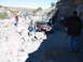 1996 Ford Bronco - Off-roading adventure in a canyon with multiple Jeeps on a challenging trail.