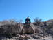 1996 Ford Bronco - A person enjoys a moment of rest on a rock formation in a desert environment.