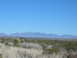 1996 Ford Bronco - A wide view of a desert landscape scrub brush and distant mountains under a bright blue sky.