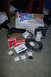 1968 Ford Mustang - Collection of 1968 Ford Mustang parts, including a grille emblem and intake, laid out on the floor.