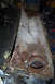 1968 Ford Mustang - The firewall and inner fender of a 1968 Ford Mustang show significant rust damage, indicating a need for restoration.