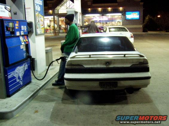 1993 Ford Probe refueling at a gas station at night